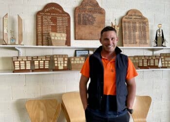 Deloraine Squash Club's Cory Youd in front of the club's leaderboards and trophies