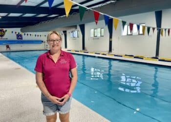 Mel's Swim School, Mel Bussey standing next to the Deloraine Primary School's swimming pool.