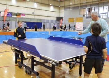 Variety kids playing table tennis on the sports day