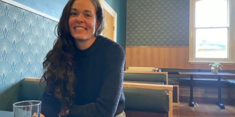 Hop to Harvest - Emma Seddon sitting at a table with a beer in The British pub in Deloraine, Tasmania