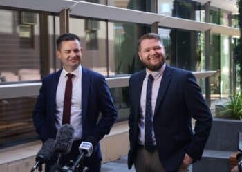 Casey Farrell, Labor politician on the right in a blue suit.