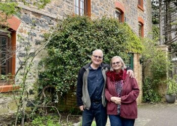 The two proprietors of Carrick Mill Antiques, Andrew and Susanne standing outside of the four or five story building.